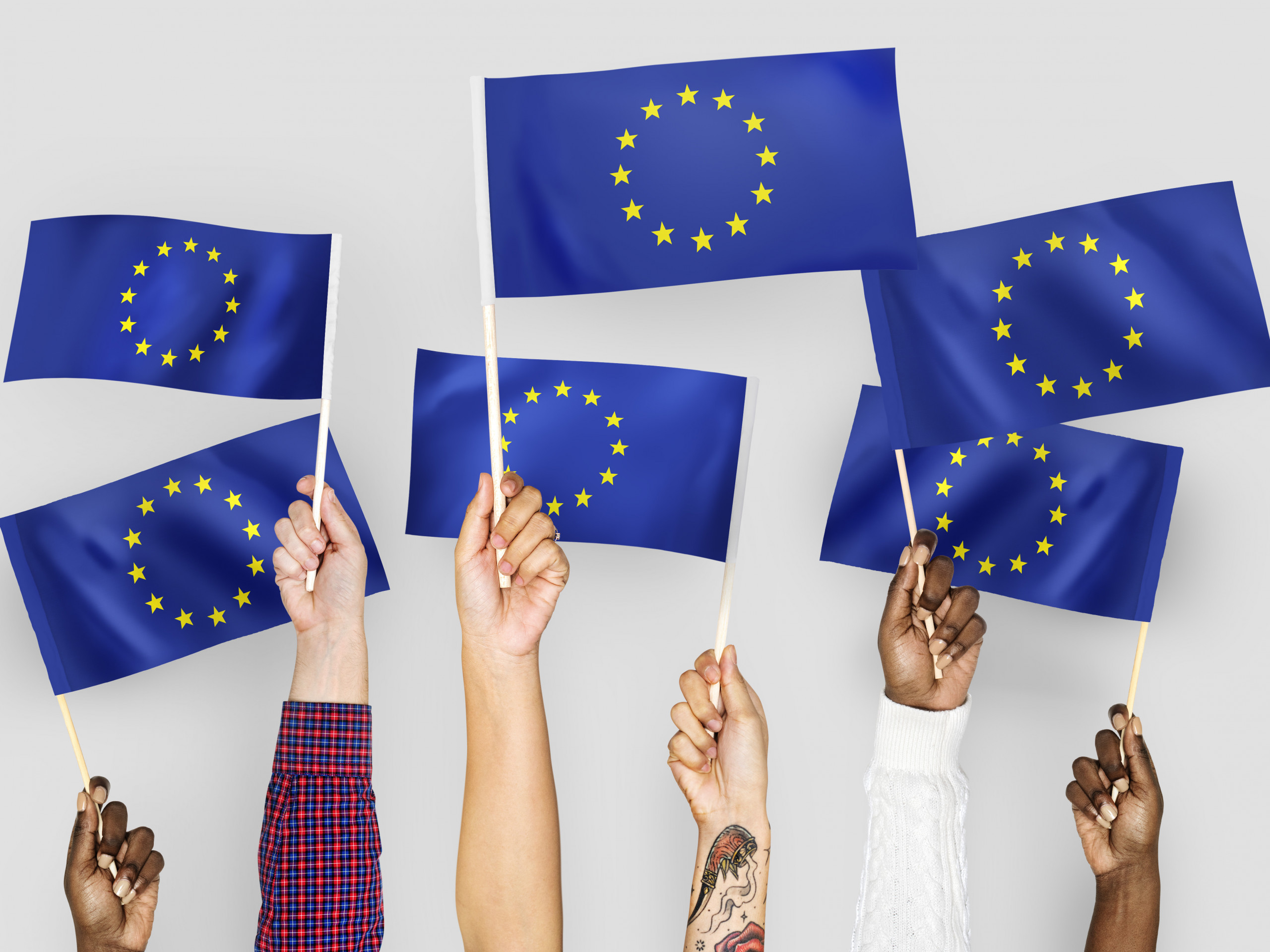 Six hands holding EU-flags